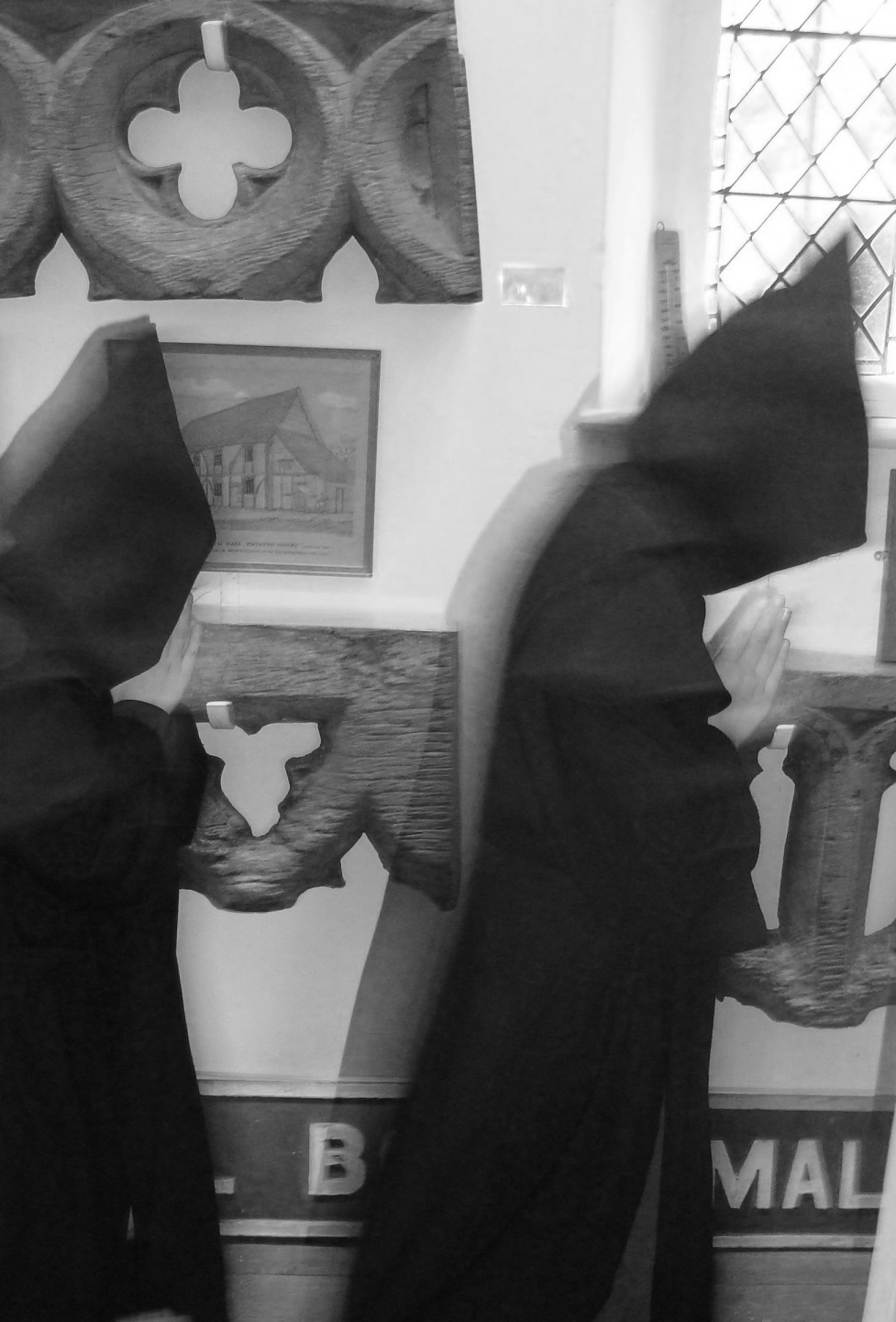 Two young Benedictine monks appearing on the upstairs corridor